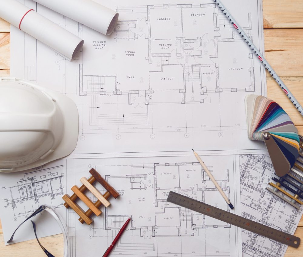 Architecture drawing desk, construction site working with blueprints in the office top view.