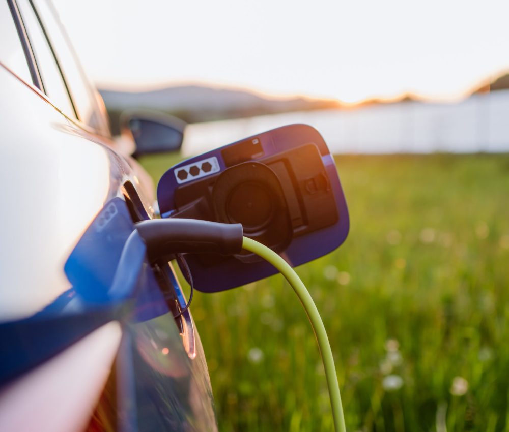 Close up of an electric car charging, concept of ecology and sustainability.